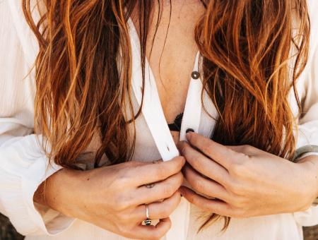 Woman Holding Buttons of Clothes