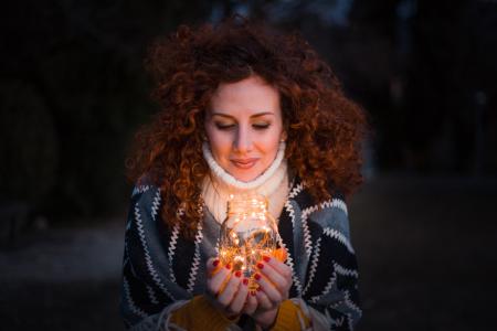 Woman Holding Clear Glass Jar Filled With Lights