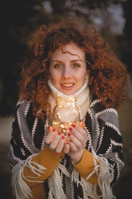 Woman Holding Clear Glass Jar With String Lights