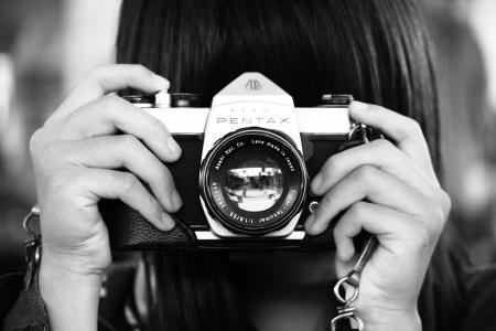 Woman Holding Dslr Camera in Grayscale Photography