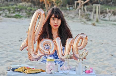 Woman Holding Gold Foil Balloons