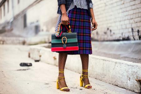 Woman Holding Green and Red Leather Handbag