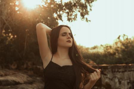 Woman Holding Her Hair Standing Near Tree