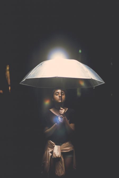 Woman Holding Illuminated Lamp at Night