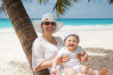 Woman Holding Infant on Beach