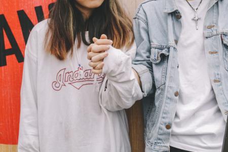 Woman Holding Man's Hand During Day