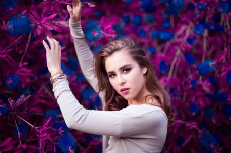 Woman Holding Purple and Blue Flowers