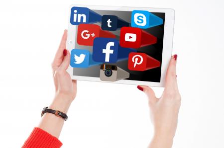 Woman Holding Tablet with Social Media Networks Logos