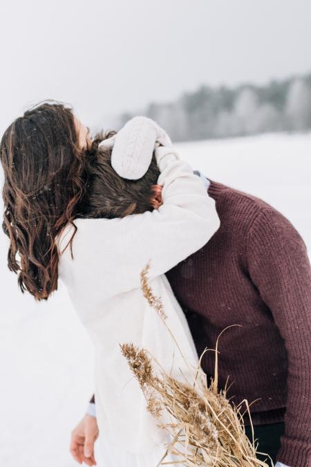 Woman Hugging Man in Black Sweatshirt