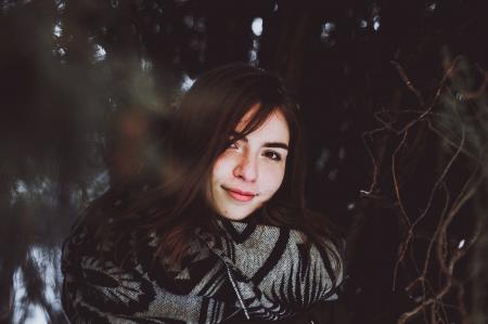 Woman in Black and Gray Sweater Posing Smile for Photo