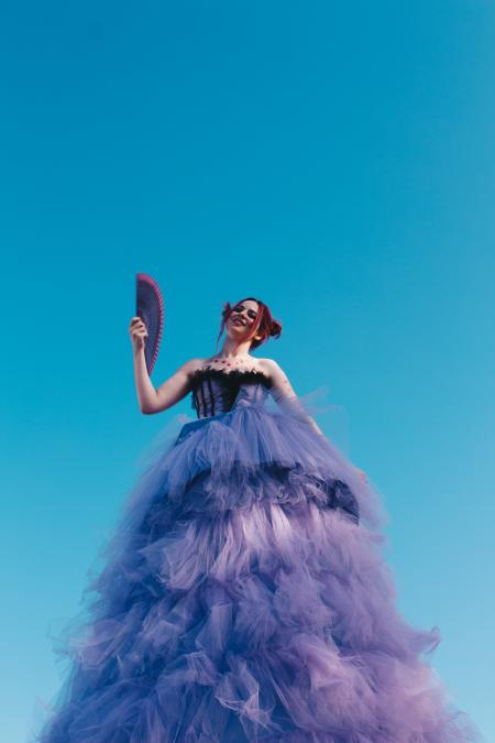 Woman in Black and Purple Ruffle Dress Holding Hand Fan