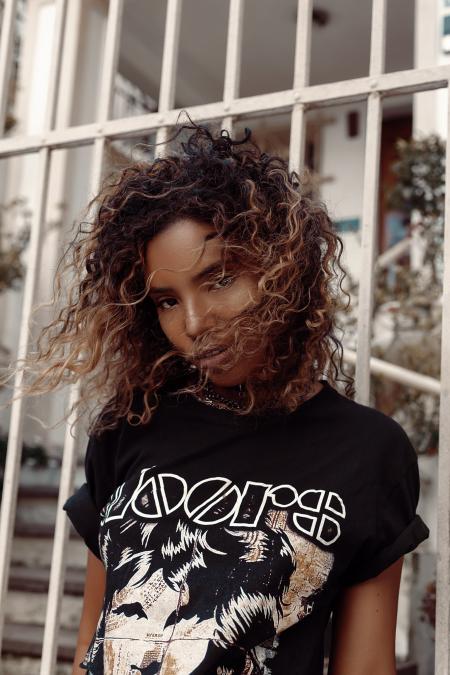 Woman in Black and White Crew-neck Shirt Posing for Photo