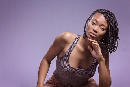 Woman in Black and White Tank Top Posing for Picture