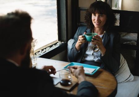 Woman in Black Blazer Holding Blue Cup