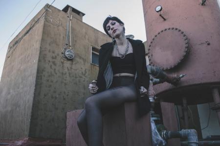 Woman in Black Crop Top Sitting on Brown Chair