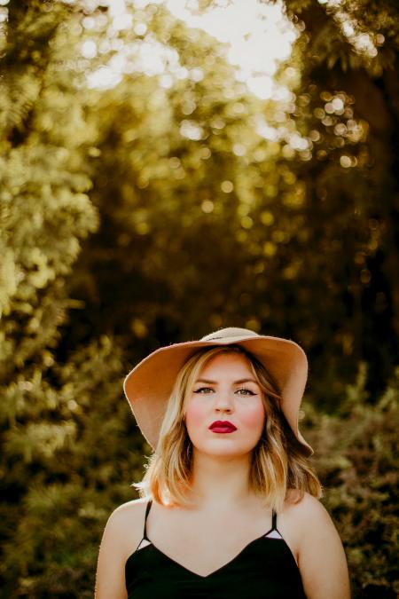 Woman in Black Dress Wearing Sunhat during Daytime