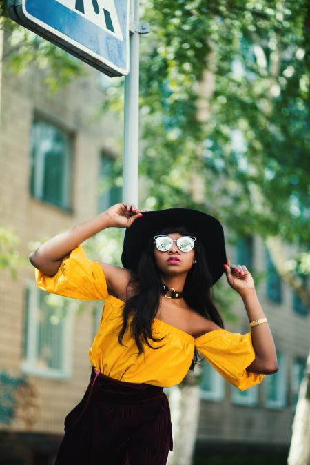 Woman in Black Hat and Yellow Top Taking Selfie