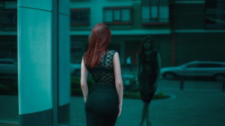 Woman in Black Lace Bodycon Dress in Front of Building Mirror