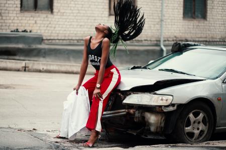 Woman in Black Tank Top Sitting in Front of Car