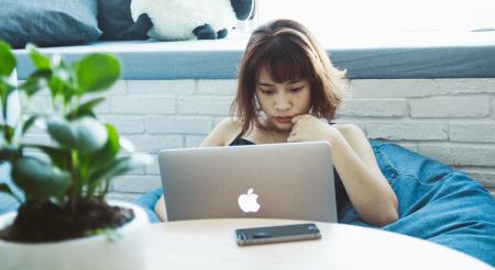 Woman in Black Tank Top Using Silver Macbook