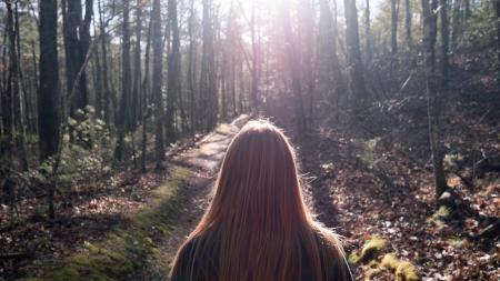 Woman in Black Top Standing Between Trees