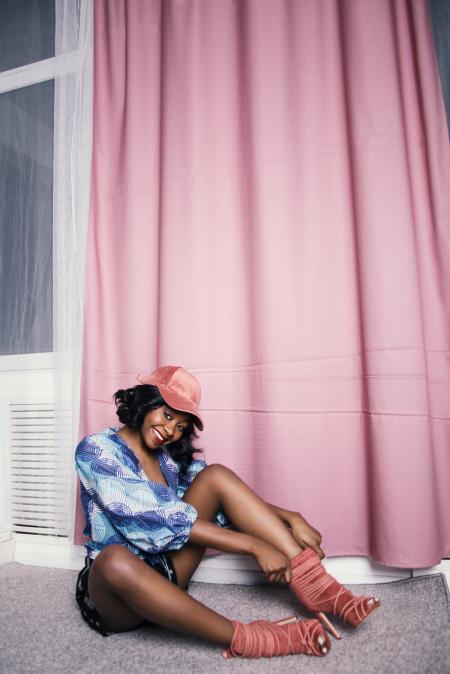 Woman in Blue Scoop-neck Blouse Near Pink Curtain