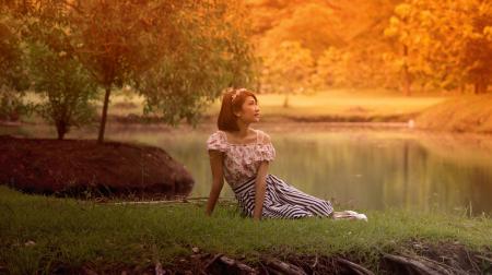 Woman in Dress Lying on Grass