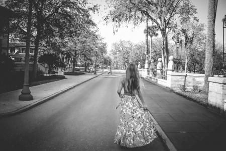 Woman in Floral Dress Standing on Road