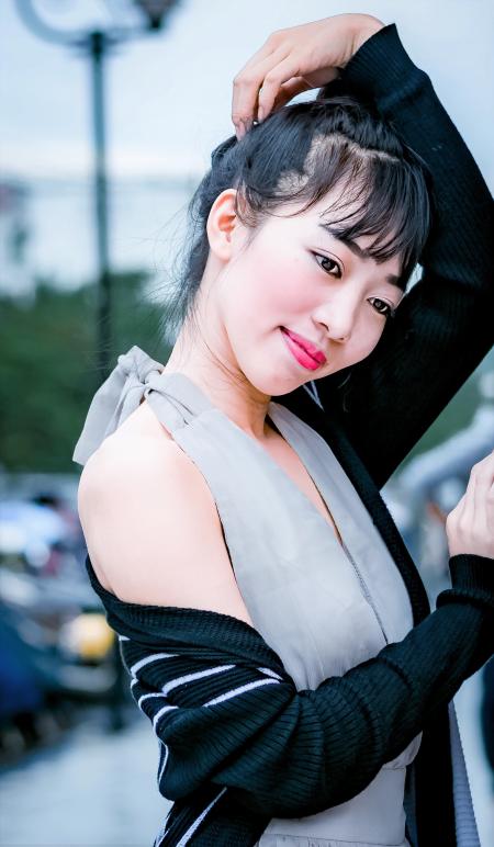 Woman in Gray Halter Dress Standing on Street