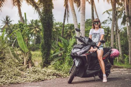 Woman in Gray Shirt Riding Black Motor Scooter