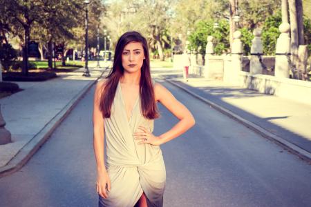 Woman in Gray Sleeveless Mini Dress Standing on Pavements