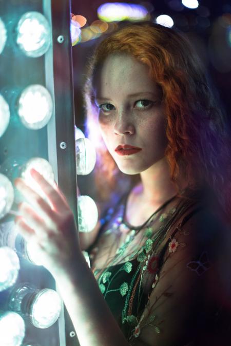 Woman in Green Dress Holding Gray Steel Frame