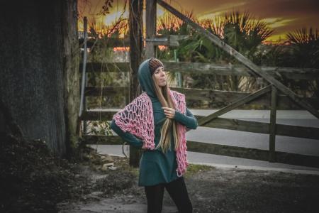 Woman in Green Long-sleeved Dress Standing Near Brown Wooden Fence