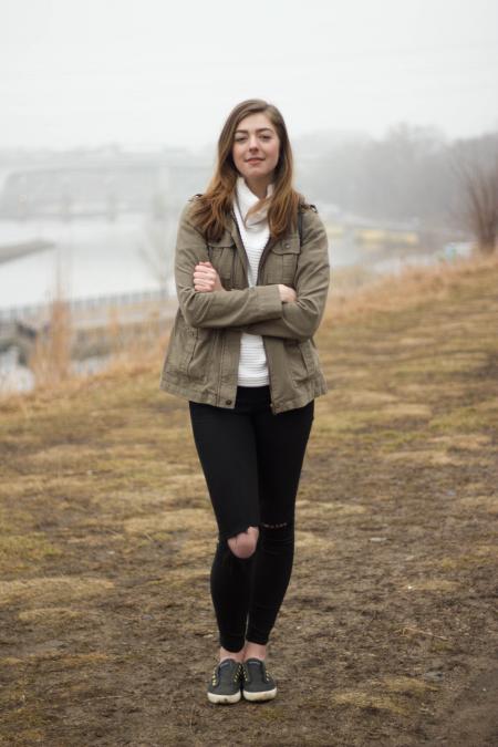 Woman in Grey Jacket Wearing Black Distress Pants While Crossing Her Arms