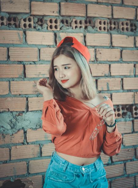 Woman in Orange Long-sleeved Shirt With Blue Denim Bottoms