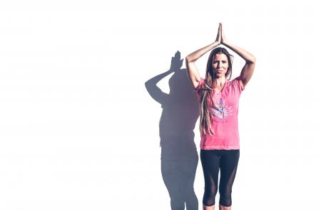 Woman in Pink Crew-neck T-shirt and Black Leggings Standing Near White Wall