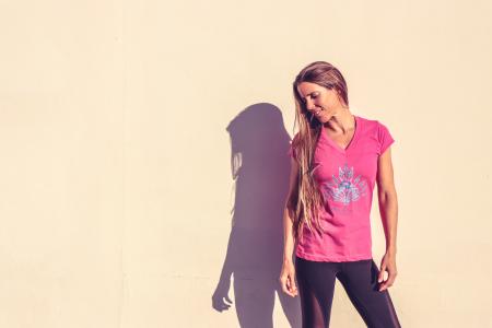 Woman in Pink V-neck Cap-sleeved Shirt Standing Near Wall