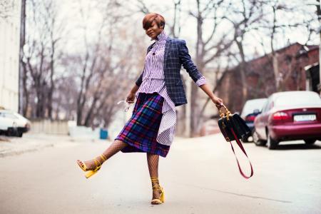 Woman in Purple Top and Plaid Skirt Near Car