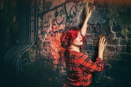 Woman in Red Black and White Plaid Holding Gray Concrete Wall