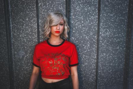 Woman in Red Shirt Standing Near Wall