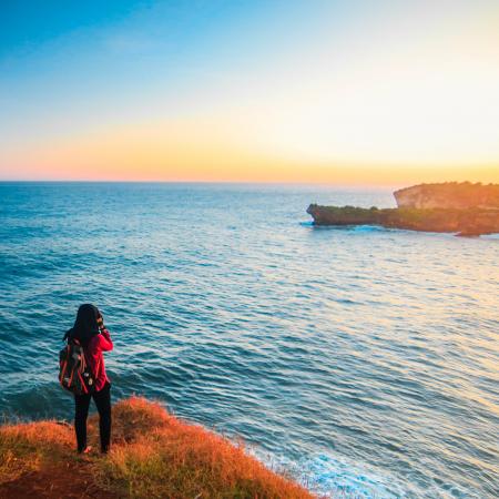 Woman in Red Shirt Wearing Gray and Pink Backpack Beside Body of Water