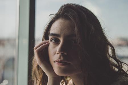 Woman in Room Near Glass Window