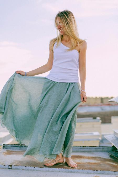 Woman in White and Green Dress Standing on Dock