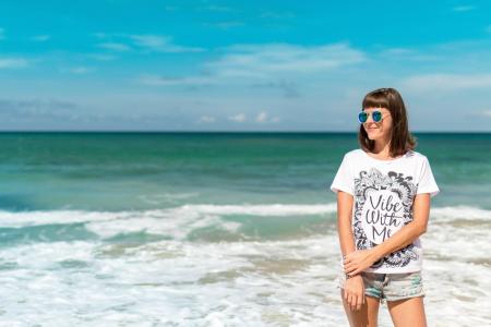Woman in White Crew-neck Shirt Near Sea Shore
