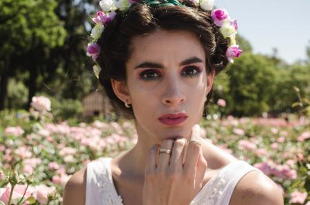 Woman in White Floral Headdress and White Sleeveless Top Behind Pink Flower Field at Daytime