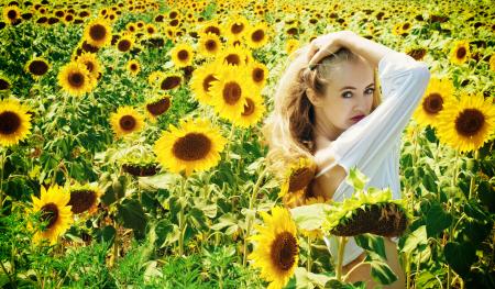 Woman in White Long Sleeve Shirt on Sunflower Field