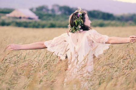 Woman in White Mesh Dress Surrounded by Brown Plants