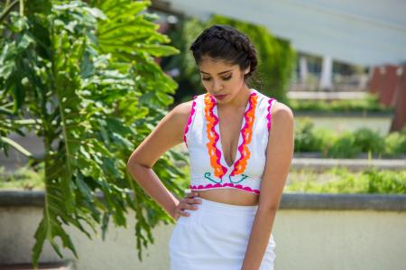 Woman In White Plunging Neckline Top And White Skirt