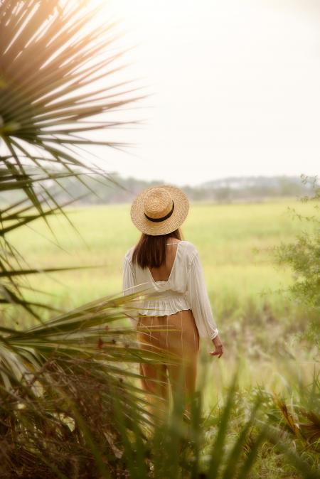 Woman in White Scoop-neck Long-sleeved Blouse With Brown Pants