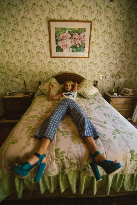 Woman in White Shirt Lying on White and Green Bed